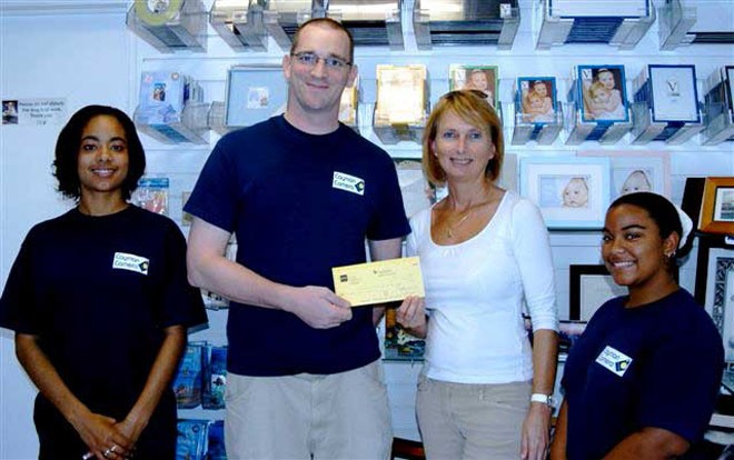 Jane Moon, Principal Organizer of the event for the CISC, receives a sponsorship cheque from Bouke Maddock, Manager, Cayman Camera and his staff. © Byte Class http://bytechamps.org/